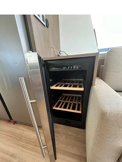Voyager Yacht Photos Pics Open wine cooler with wooden shelves in a modern kitchen, Bali 5.4 model, 2023.