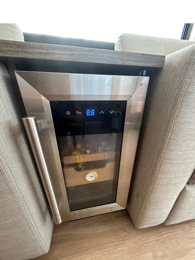 Voyager Yacht Photos Pics Modern wine cooler with digital display, integrated into a stylish wooden cabinet.