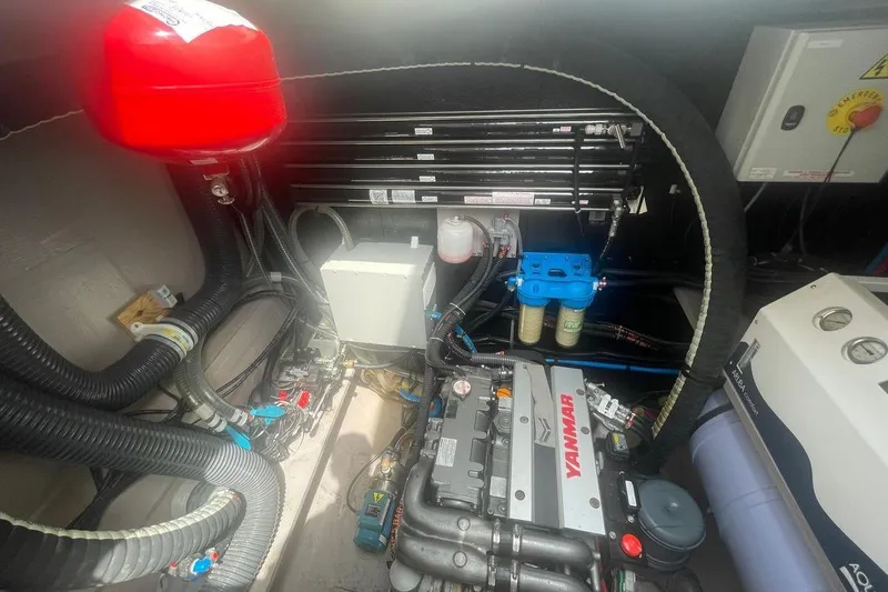 Voyager Yacht Photos Pics Engine room of a 2023 Bali 5.4 yacht with Yanmar engine and various components.