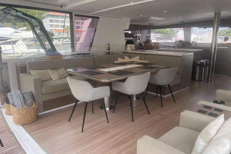 Voyager Yacht Photos Pics Luxurious interior of 2023 Bali 5.4 yacht with elegant dining area and modern furnishings.