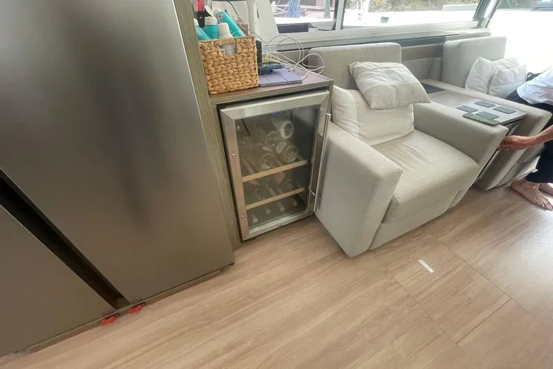 Voyager Yacht Photos Pics Modern yacht interior with mini fridge, cozy seating, and wooden flooring on a 2023 Bali 5.4.