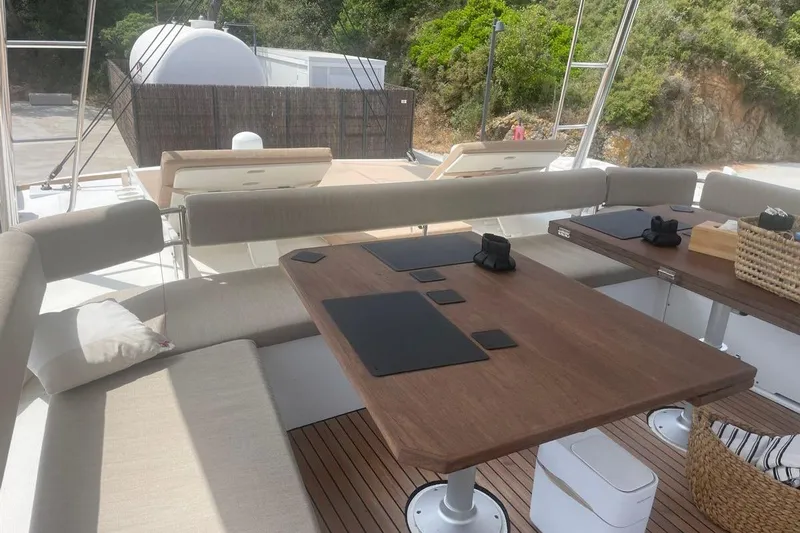 Voyager Yacht Photos Pics Luxurious 2023 Bali 5.4 yacht interior with elegant seating and wooden table.