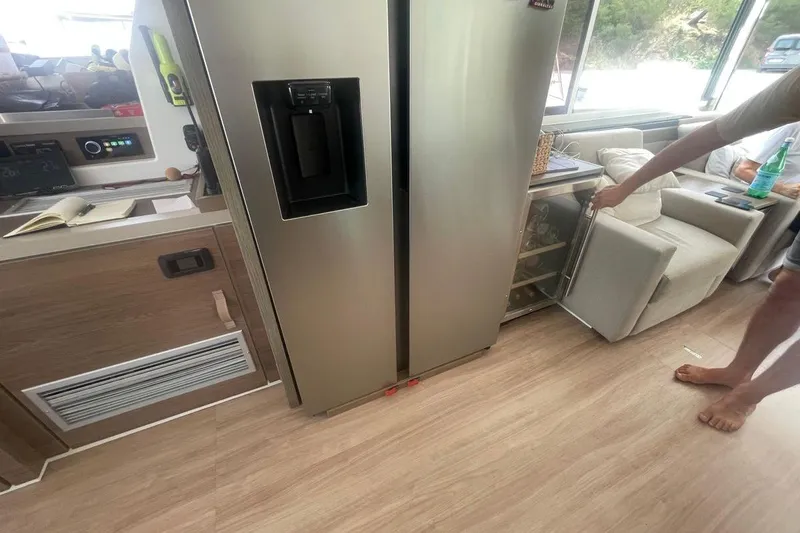 Voyager Yacht Photos Pics Modern kitchen interior on a Bali 5.4 yacht, featuring a stainless steel refrigerator.