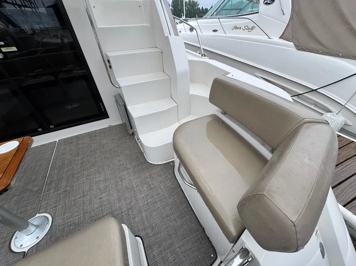 Casa De Luz Yacht Photos Pics 2014 Carver C40 Command Bridge interior with seating and stairs, featuring beige upholstery.