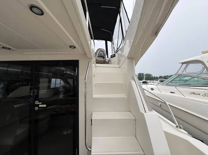 Casa De Luz Yacht Photos Pics 2014 Carver C40 Command Bridge yacht with stairs to upper deck, docked beside other boats.