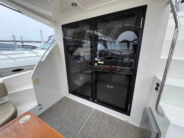 Casa De Luz Yacht Photos Pics 2014 Carver C40 Command Bridge yacht interior with glass doors and seating area.