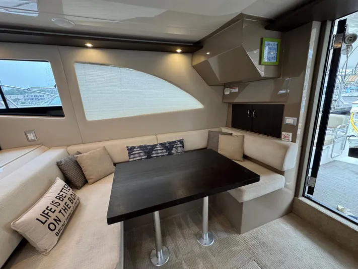 Casa De Luz Yacht Photos Pics Interior of 2014 Carver C40 Command Bridge yacht with cozy seating and dining area.