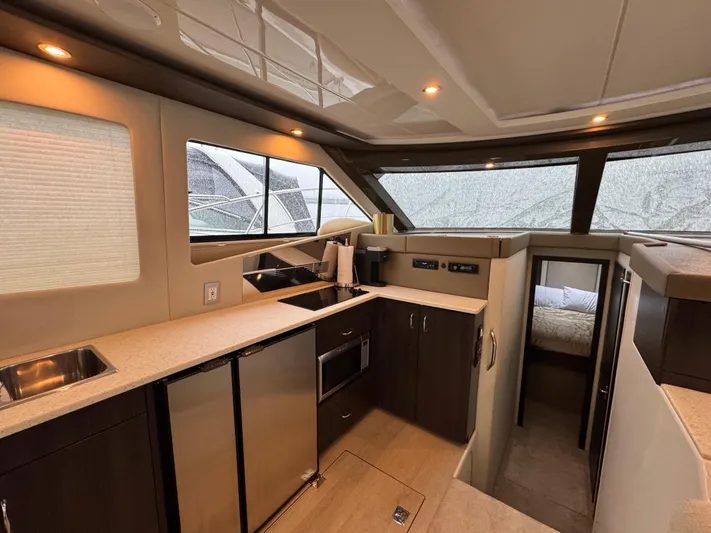 Casa De Luz Yacht Photos Pics Interior of 2014 Carver C40 Command Bridge yacht, featuring modern kitchen and cozy cabin.