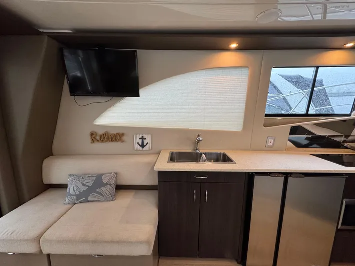 Casa De Luz Yacht Photos Pics Interior of 2014 Carver C40 Command Bridge with kitchenette and seating area.