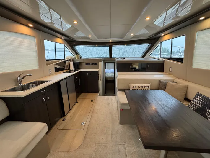 Casa De Luz Yacht Photos Pics Luxurious interior of 2014 Carver C40 Command Bridge yacht with modern kitchen and seating area.
