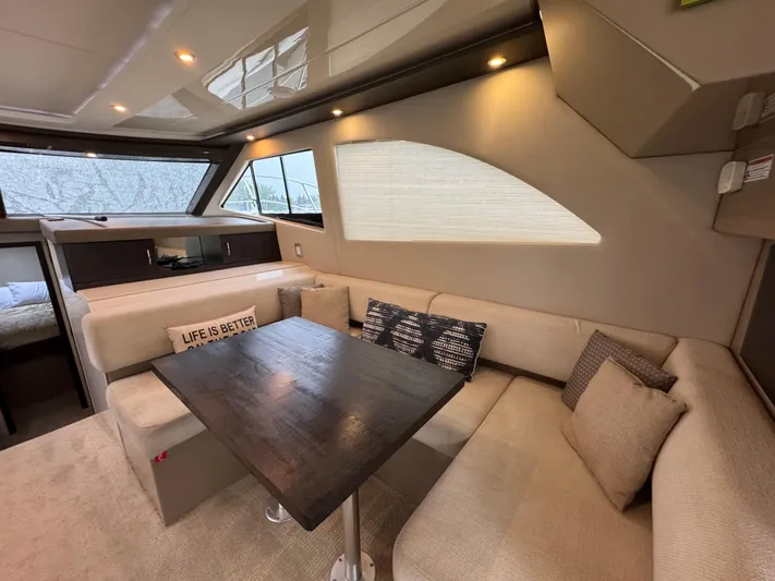 Casa De Luz Yacht Photos Pics Luxurious interior of 2014 Carver C40 Command Bridge yacht with cozy seating and dining area.