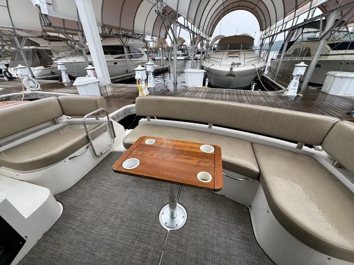 Casa De Luz Yacht Photos Pics 2014 Carver C40 Command Bridge yacht interior with seating and wooden table at marina.