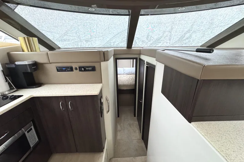 Casa De Luz Yacht Photos Pics Interior of 2014 Carver C40 Command Bridge yacht with modern kitchen and cozy cabin.