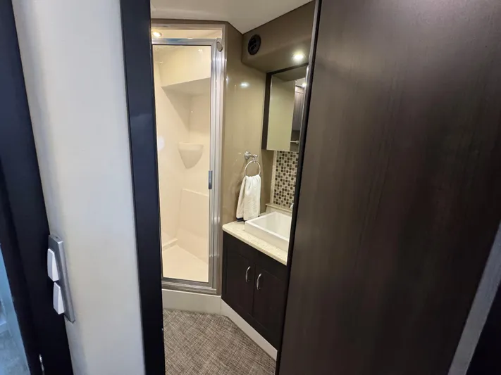 Casa De Luz Yacht Photos Pics Bathroom interior of 2014 Carver C40 Command Bridge yacht, featuring shower and sink.