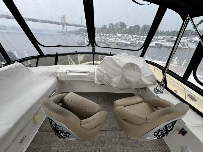 Casa De Luz Yacht Photos Pics 2014 Carver C40 Command Bridge interior with beige seating and panoramic windows.