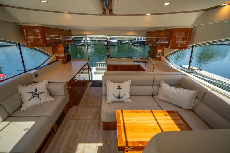  Yacht Photos Pics Luxurious interior of 2020 Riviera 525 SUV yacht with elegant seating and nautical decor.