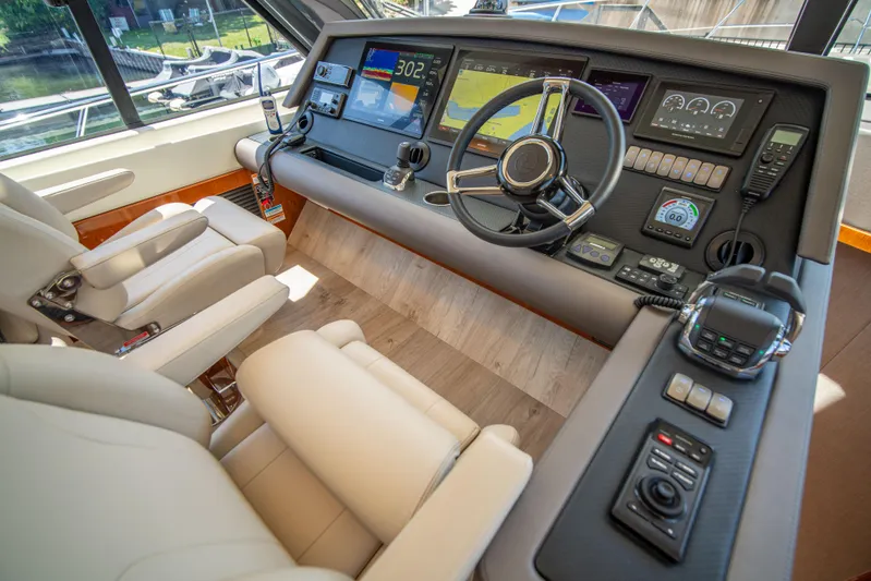  Yacht Photos Pics Luxurious 2020 Riviera 525 SUV helm with advanced navigation controls and plush seating.