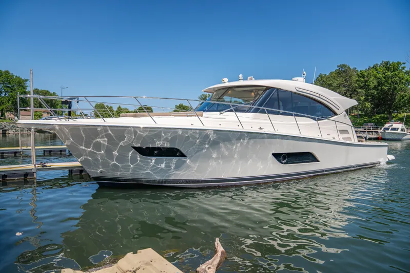  Yacht Photos Pics 2020 Riviera 525 SUV yacht docked on a sunny day.