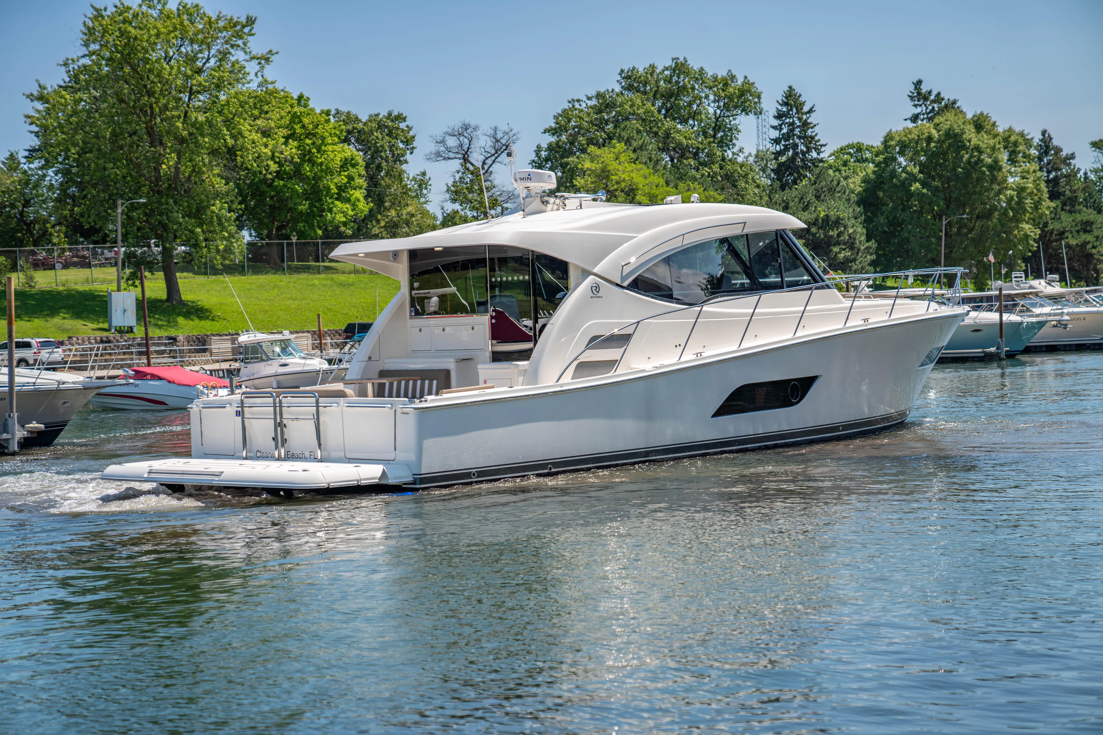  Yacht Photos Pics 2020 Riviera 525 SUV yacht cruising on a serene lake.