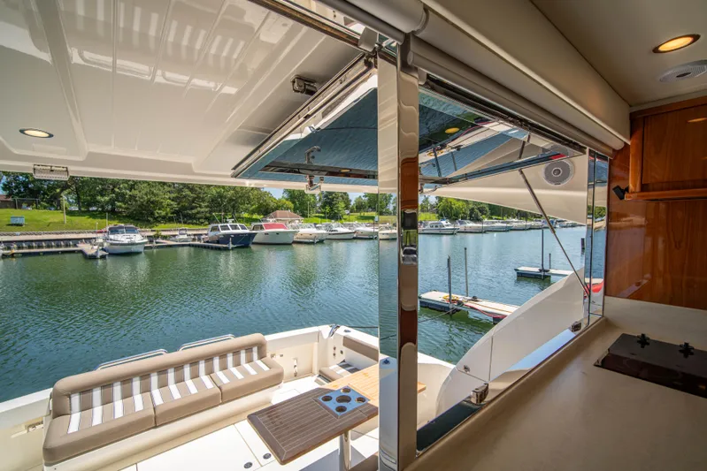  Yacht Photos Pics Interior view of 2020 Riviera 525 SUV yacht overlooking marina.