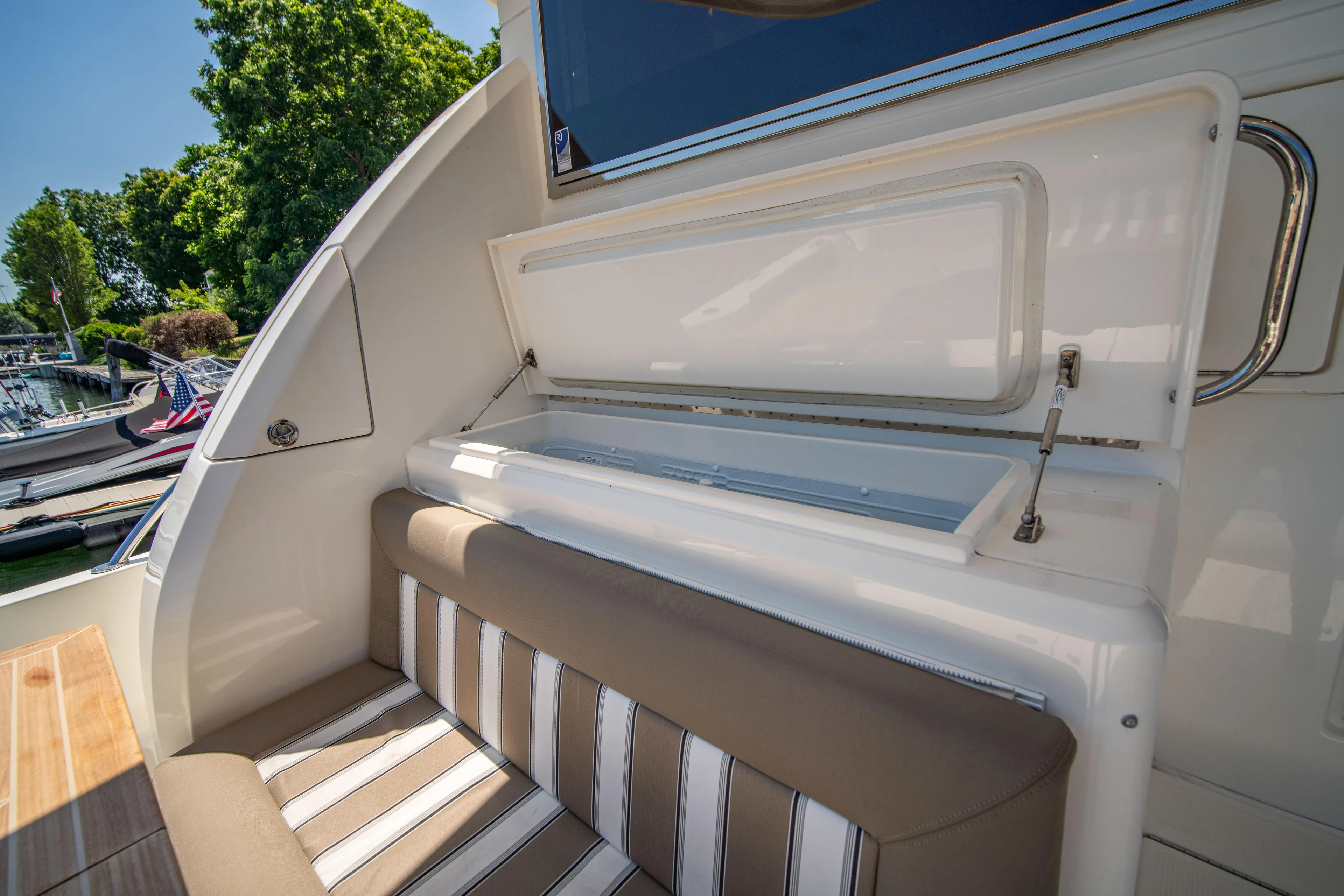  Yacht Photos Pics 2020 Riviera 525 SUV interior with striped seating and storage compartment.