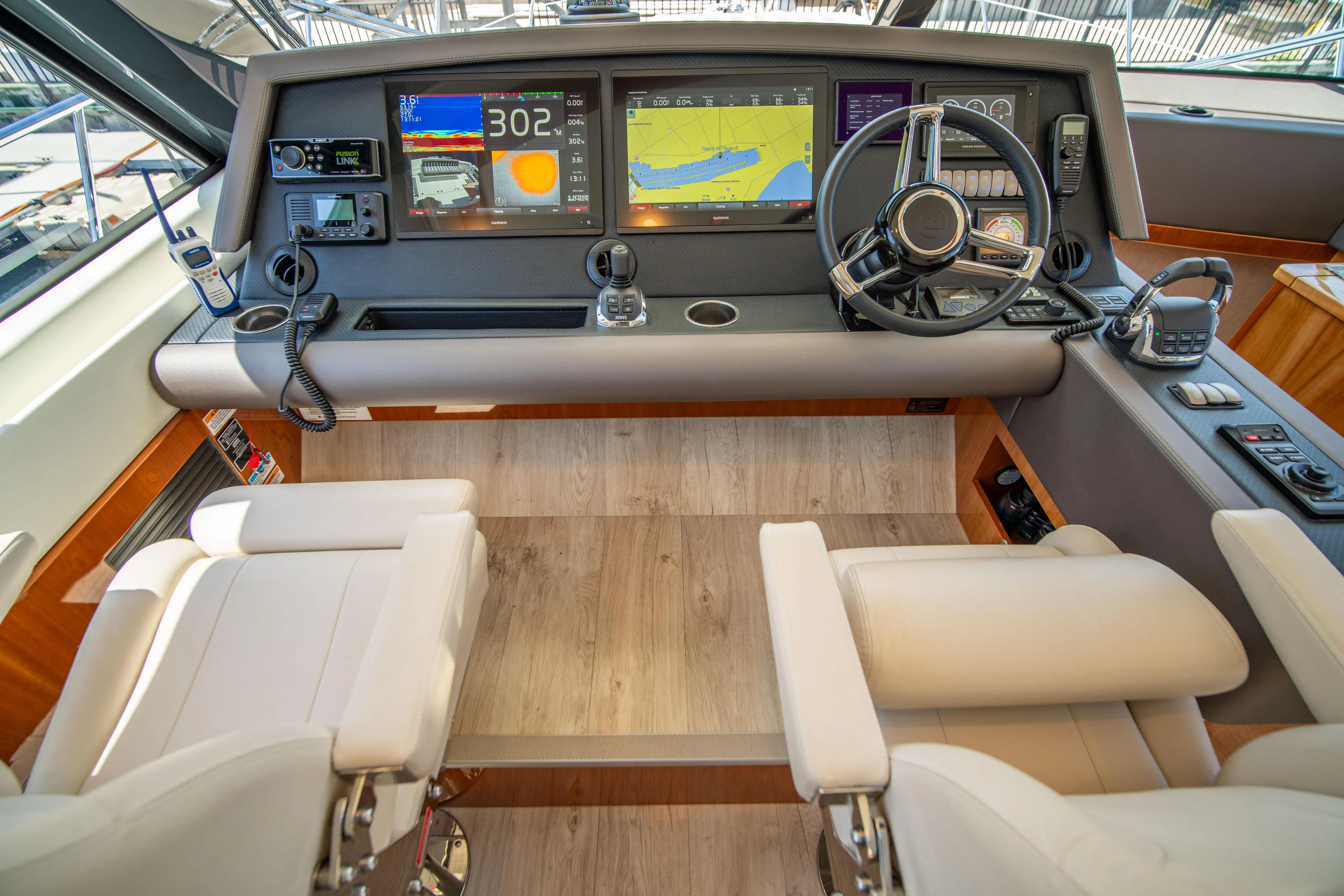  Yacht Photos Pics Luxurious 2020 Riviera 525 SUV helm with advanced navigation displays and plush seating.