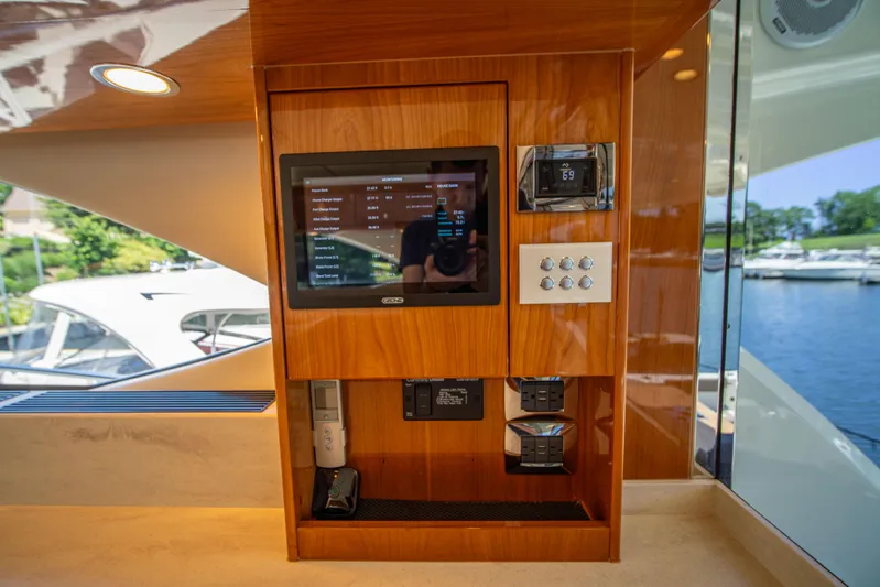  Yacht Photos Pics 2020 Riviera 525 SUV interior control panel with touchscreen and wooden finish.