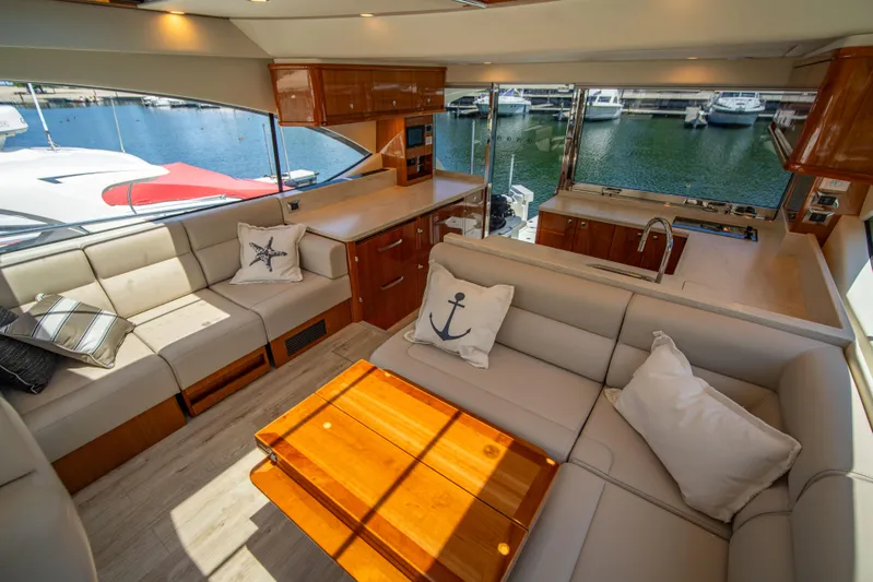 Yacht Photos Pics Luxurious interior of 2020 Riviera 525 SUV yacht with marina view.