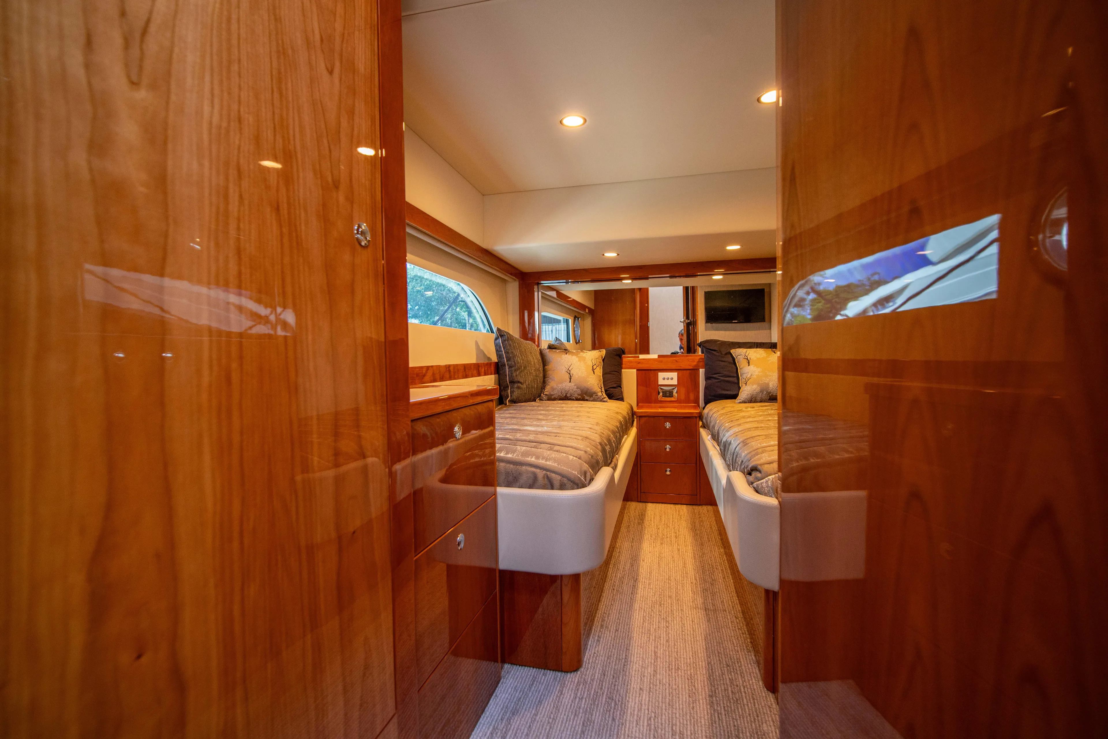  Yacht Photos Pics Luxurious 2020 Riviera 525 SUV cabin interior with twin beds and wooden finish.