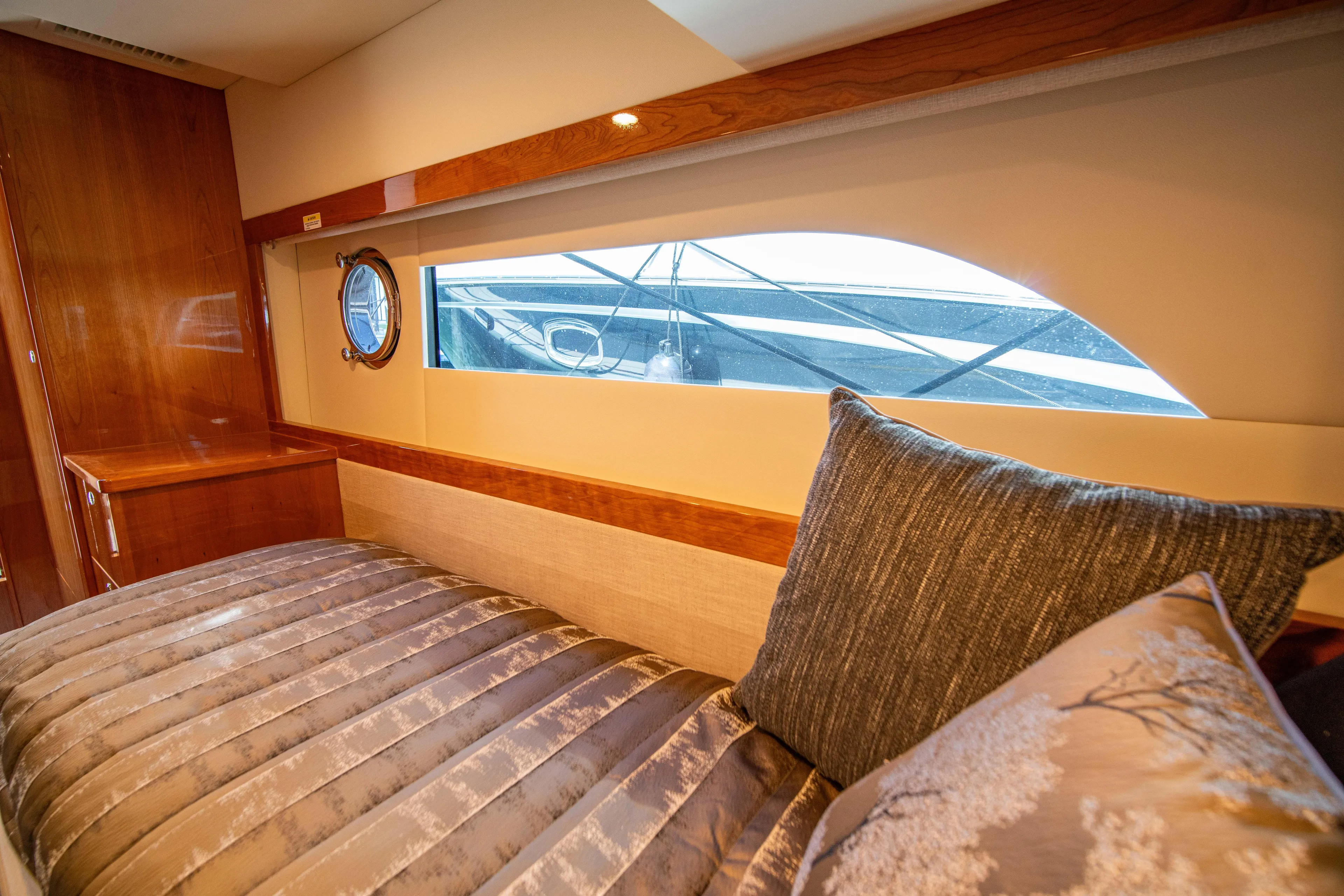  Yacht Photos Pics Luxurious interior cabin of 2020 Riviera 525 SUV yacht with elegant bedding.