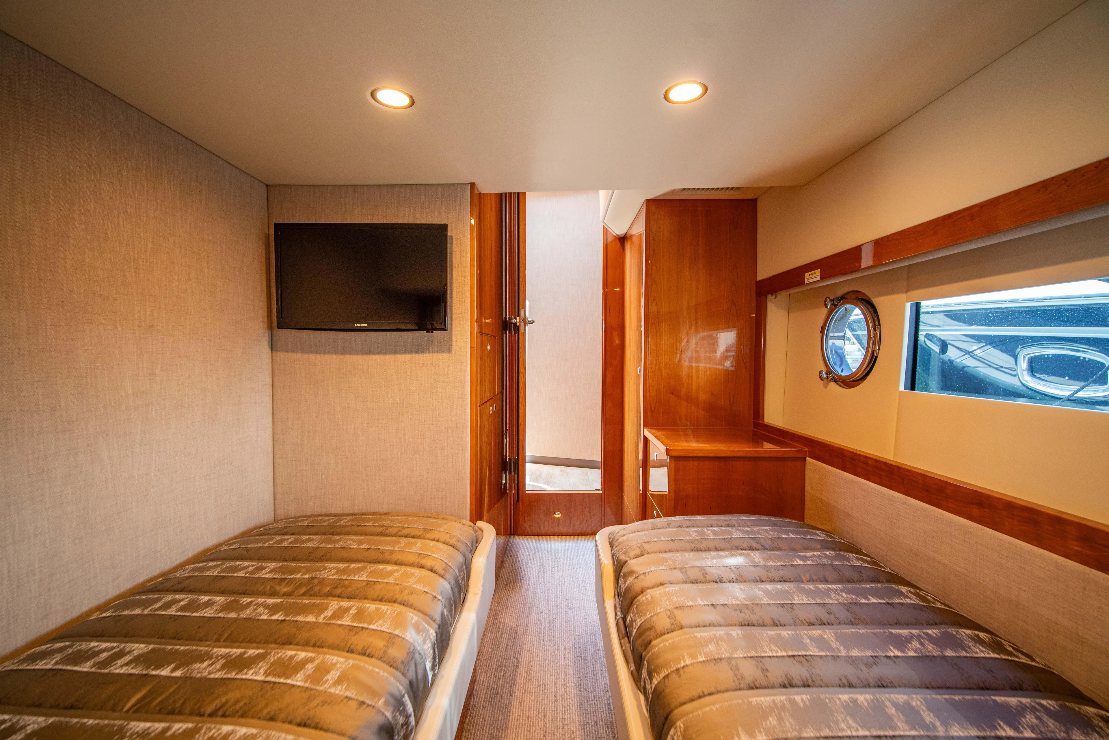  Yacht Photos Pics Interior of 2020 Riviera 525 SUV with twin beds and porthole window.