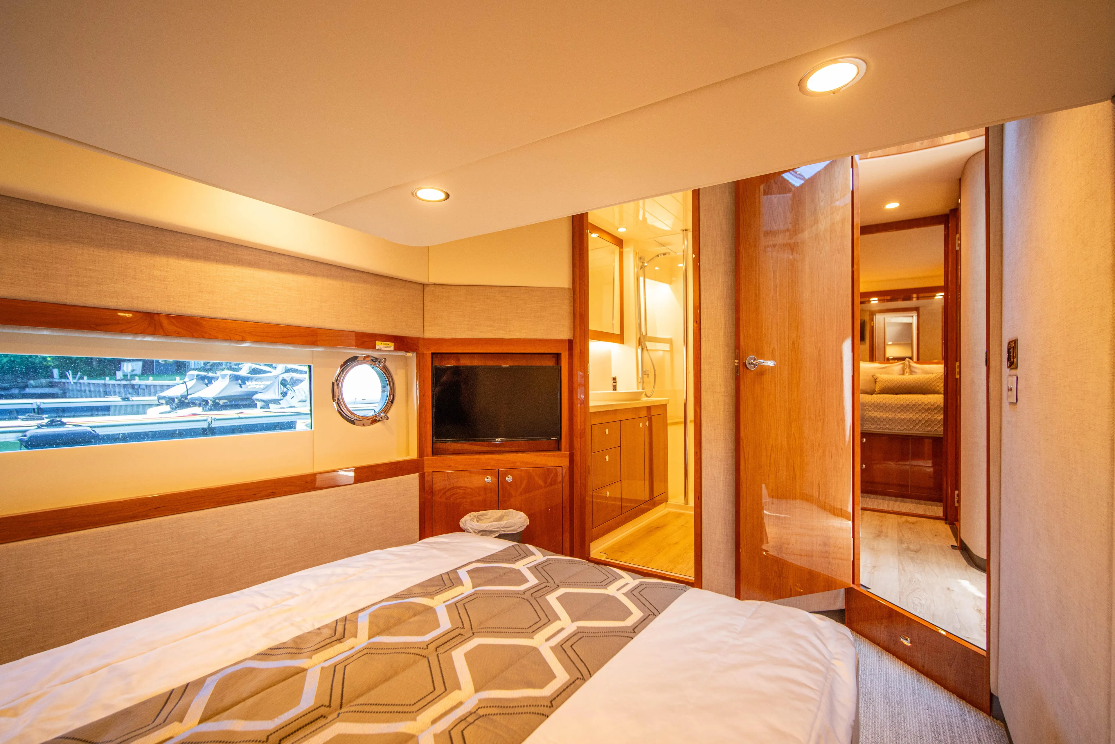  Yacht Photos Pics Luxurious interior of 2020 Riviera 525 SUV yacht bedroom with modern amenities.