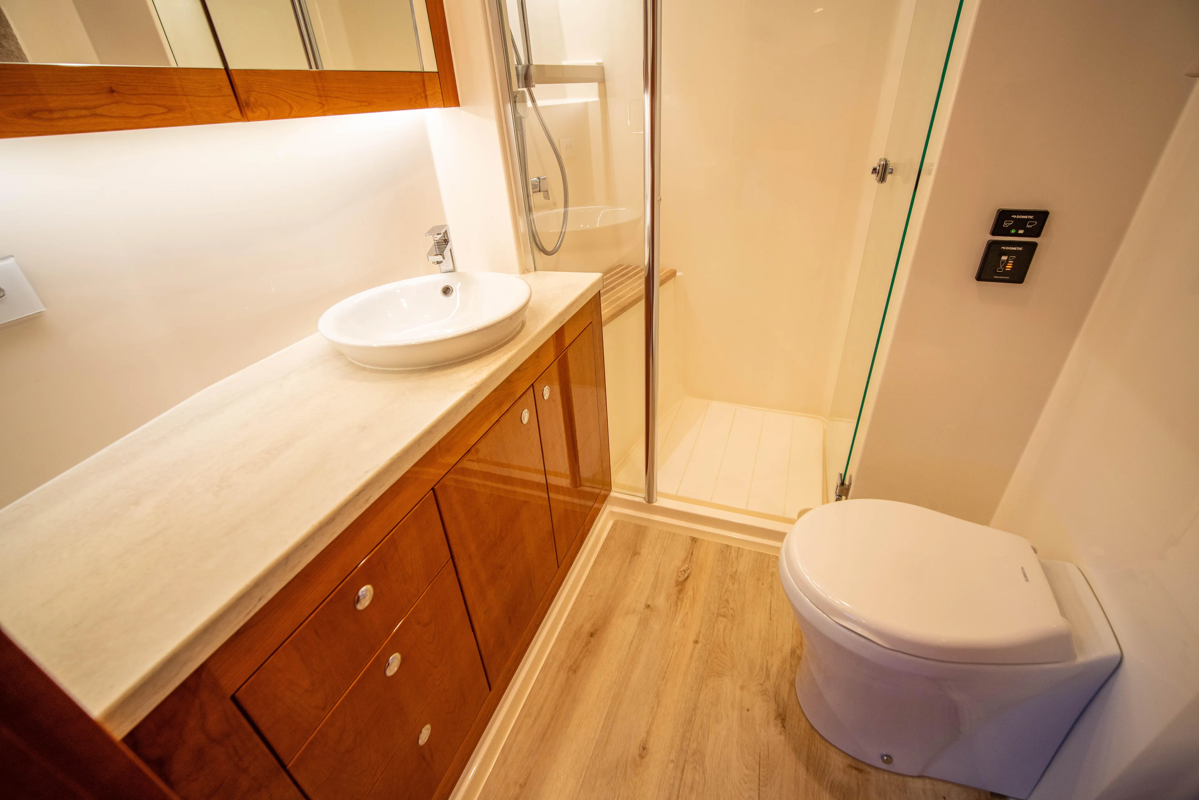  Yacht Photos Pics Luxurious bathroom in 2020 Riviera 525 SUV yacht with modern fixtures and wooden cabinetry.