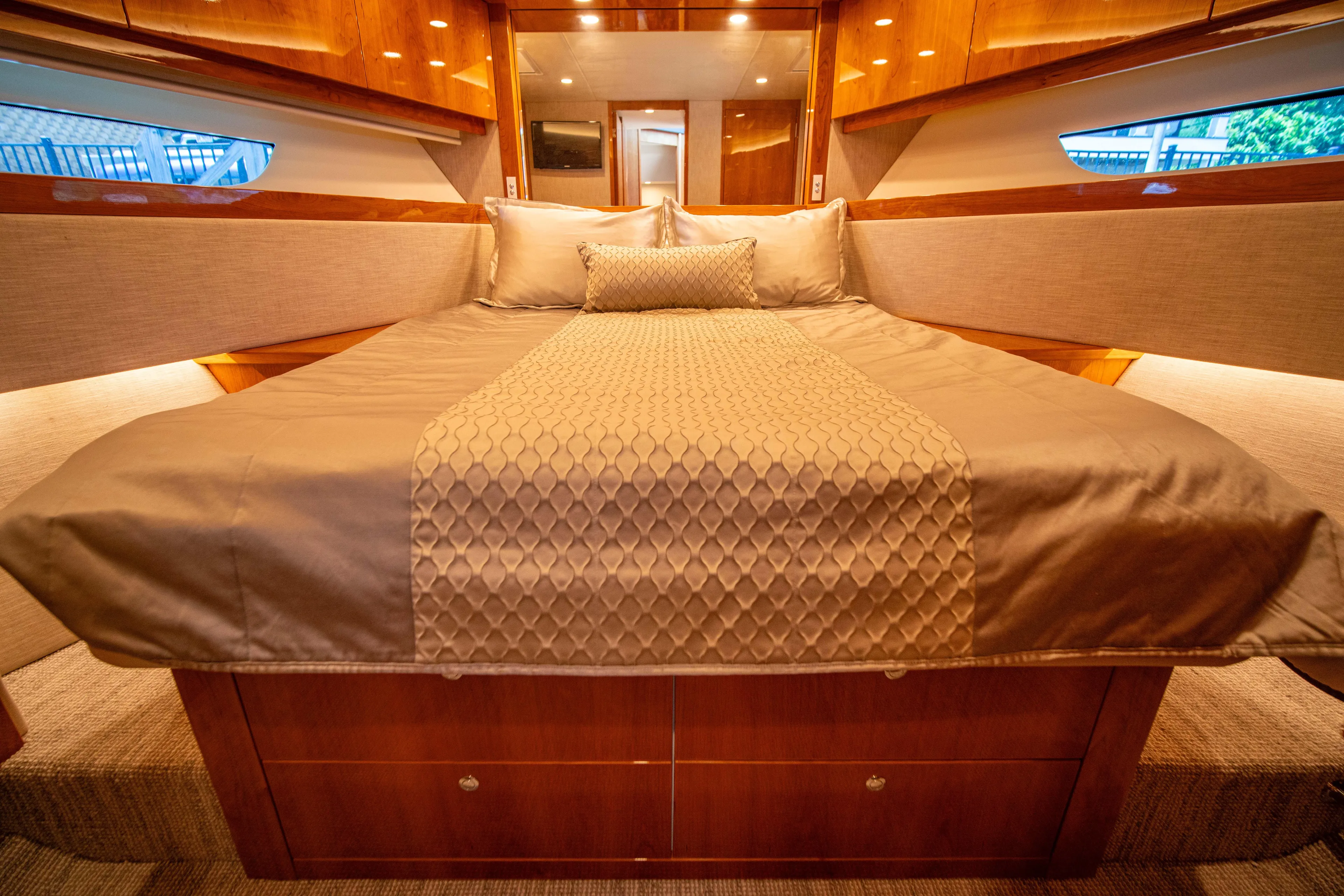  Yacht Photos Pics Luxurious bedroom interior of 2020 Riviera 525 SUV yacht with elegant bedding.