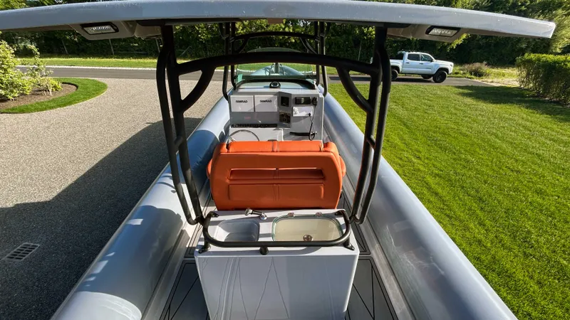  Yacht Photos Pics 2023 Fluid Watercraft M35 boat with orange seat and sleek design on a sunny day.