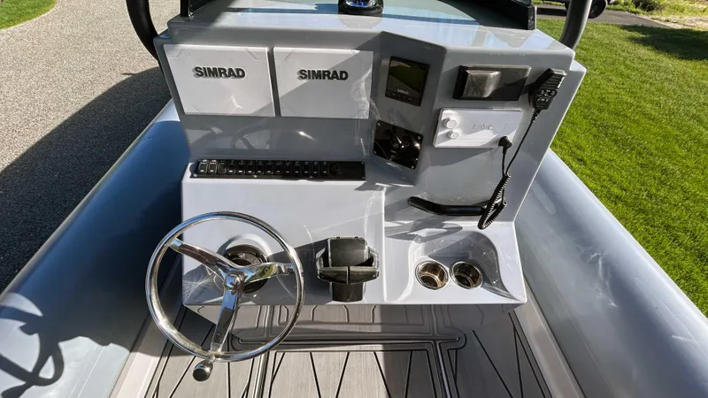  Yacht Photos Pics 2023 Fluid Watercraft M35 boat dashboard with steering wheel and Simrad electronics.