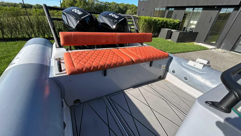  Yacht Photos Pics 2023 Fluid Watercraft M35 boat with orange seating and dual engines, docked outdoors.