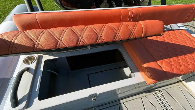  Yacht Photos Pics 2023 Fluid Watercraft M35 boat with orange diamond-stitched seating and storage compartment.