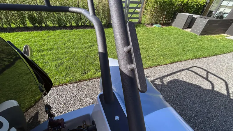  Yacht Photos Pics 2023 Fluid Watercraft M35 boat detail with sleek design, parked on a sunny lawn.