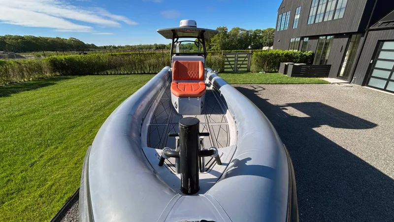  Yacht Photos Pics 2023 Fluid Watercraft M35 boat on grass near modern building, sunny day.