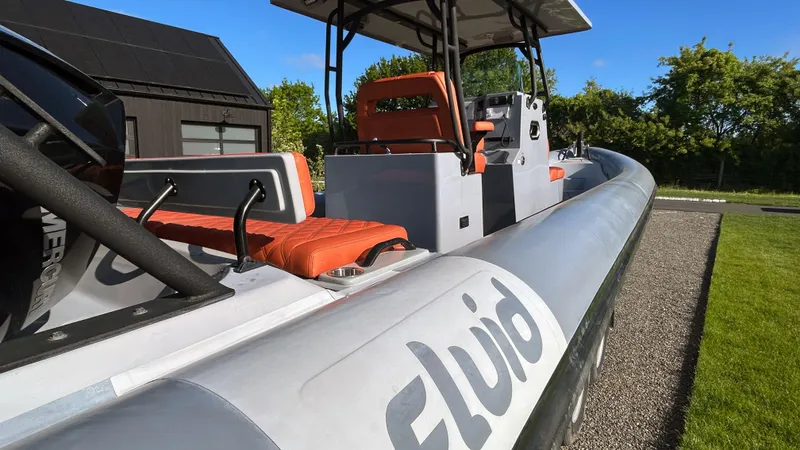  Yacht Photos Pics 2023 Fluid Watercraft M35 boat with orange seats, sleek design, and modern features.