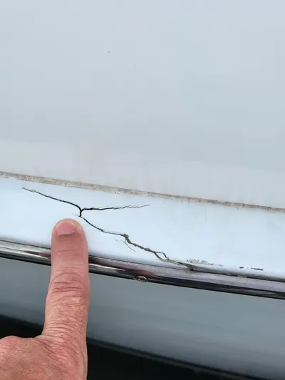 All In Yacht Photos Pics Close-up of a crack on a 2003 Robertson & Caine Lion 46 boat hull.