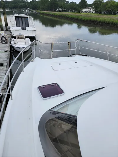 All In Yacht Photos Pics 2003 Lion Robertson & Caine Lion 46 yacht docked by a serene river.