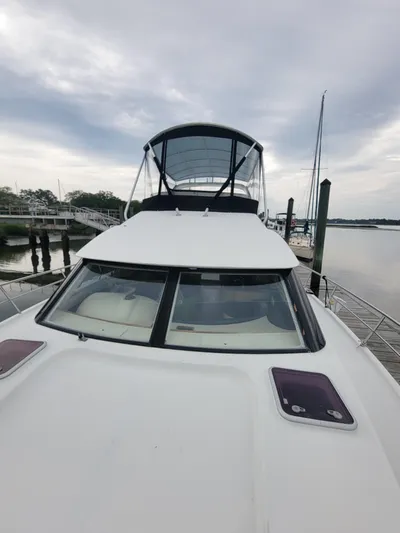 All In Yacht Photos Pics 2003 Lion Robertson & Caine Lion 46 yacht docked by a serene waterfront.