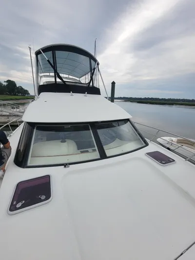 All In Yacht Photos Pics 2003 Robertson & Caine Lion 46 yacht on calm water under cloudy sky.