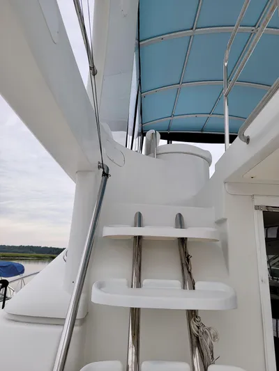 All In Yacht Photos Pics Staircase on 2003 Robertson & Caine Lion 46 yacht with blue canopy.