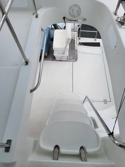 All In Yacht Photos Pics Interior view of 2003 Lion Robertson & Caine Lion 46 yacht, featuring white seating and sleek design.