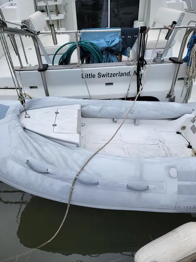 All In Yacht Photos Pics Inflatable boat docked beside 2003 Robertson & Caine Lion 46 catamaran.