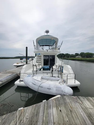 All In Yacht Photos Pics 2003 Robertson & Caine Lion 46 yacht docked with inflatable boat.