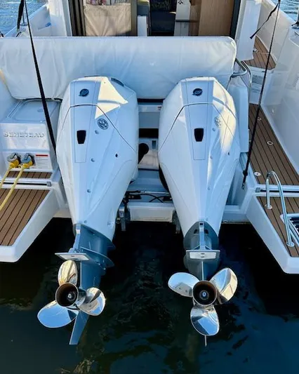 Sea Of Dreams Yacht Photos Pics 2024 Beneteau Antares 9 with dual outboard engines, rear view on water.